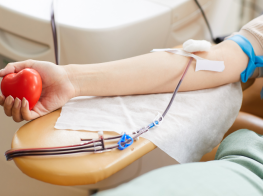 roka ar mīkstu sarkanu sird rokās un pieslēgtu sistēmu, pa kuru tek asinis